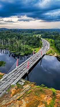 Aerial of a bridge cutting through the jungle to the future capital Ciudad de la Paz, Rio Muni, Equatorial Guinea, Africa