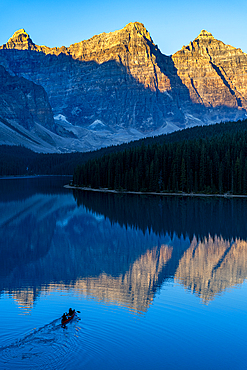 Kayaker at sunrise at Lake Moraine, Banff National Park, UNESCO World Heritage Site, Alberta, Rocky Mountains, Canada, North America