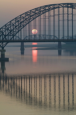 Myanmar (burma) sunset at mandalay harbour with bridges on background on the irrawady river near sagaing