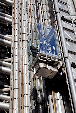 Uk staff using outdoor lifts to go to their offices at the lloyds hq in the city of london