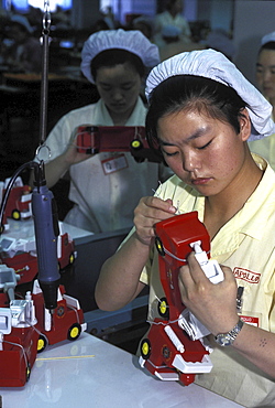 Factory assembly line, china. Guangdong province. Women working in a toy factory