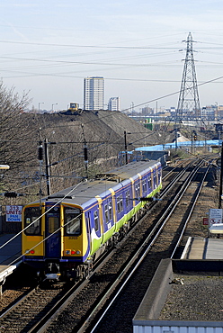 Uk. London overground trains with olympic park construction in background in east london