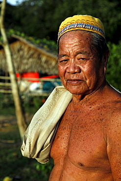 Traditional native iban dayak man in a longhouse in borneo, malaysia