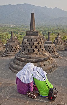 Local Muslim women visit the ancient Borobudur Buddhist Temple, UNESCO World Heritage Site, near Yogyakarta, Indonesia, Southeast Asia, Asia