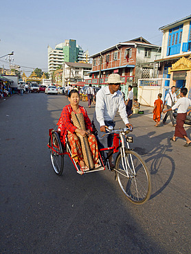 Rickshaw carrying woman in the street in Yangon (Rangoon), Myanmar (Burma), Asia