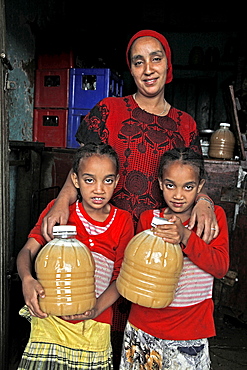 Farmer woman and family with honey produced in a co-operative in the Masha area of Ethiopia, Africa