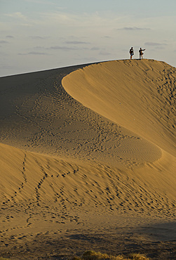 People watching the sunset and taking selfie photos at Maspalomas sand dunes, near Playa de los Ingleses, Gran Canaria, Canary Islands, Spain, Atlantic, Europe