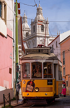 Trams and tourist buggies in the Alfama old town area of Lisbon,Portugal