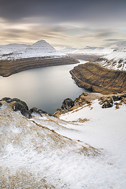 Snow-covered cliffs and mountains along Funningur fjord, Eysturoy Island, Faroe Islands, Denmark, Europe