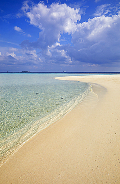 Pristine shallow waters lap against the white coral sand of a tropical beach; Havodda Island, in the far south of the Maldives, Gaafu Dhaalu atoll, Indian Ocean.