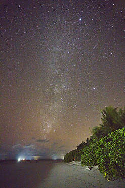 The Milky Way and Southern Cross in the southern night sky, seen from the beach on Havodda Island, Gaafu Dhaalu atoll, close to the equator, in the far south of the Maldives, in the Indian Ocean.