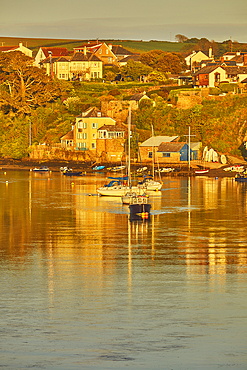 An evening sunlight view of the estuary of the River Avon, with the village of Bantham, on the south coast of Devon, Great Britain.
