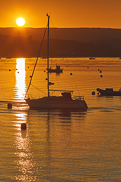 A calm and clear sunset over the estuary of the River Exe, at Exmouth, on the coast of Devon, Great Britain.