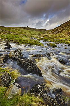 A moorland river rushes downill through a valley, en route from the moors to the sea, the River Tavy, in Dartmoor National Park, Devon, England, United Kingdom, Europe