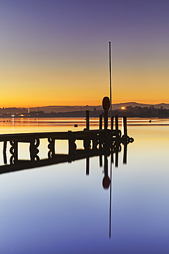 A very calm dusk scene, with a wooden jetty on the estuary of the River Teign, at Coombe Cellars, near Newton Abbot, south coast of Devon, England, United Kingdom, Europe