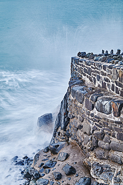 Evening shoreline, Atlantic surf crashing against the harbour wall at Hartland Quay, north Devon, England, United Kingdom, Europe