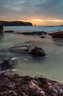 Rock formations at Sandwood Bay, with Am Buachaille sea stack in far distance, Sutherland, Scotland, United Kingdom, Europe