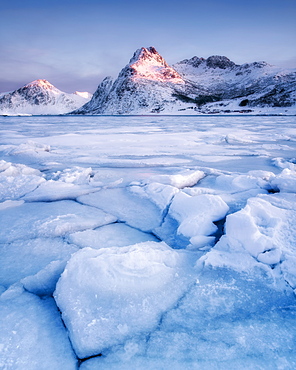 Frozen lake in front of mountain in the early morning light, Lofoten Islands, Nordland, Norway, Europe