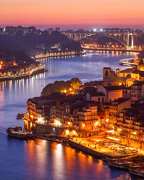 Skyline of the historic city of Porto at sunset. In the background the bridge Ponte de Arrabida. Portugal, Europe