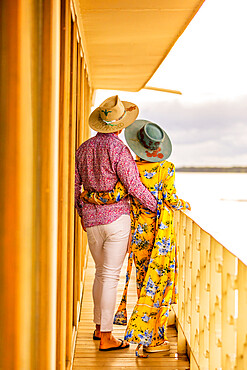 Couple enjoying the view of the Amazon River aboard a river boat, Peru, South America