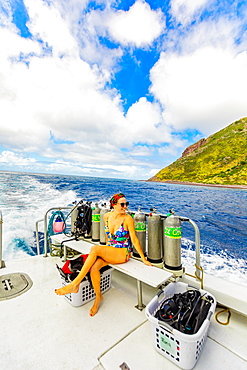 Woman taking in the sights from a boat on the water on Saba Island, Netherlands Antilles, West Indies, Caribbean, Central America