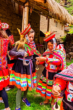 Visitors learning how to weave from the Huilloc weavers, Peru, South America