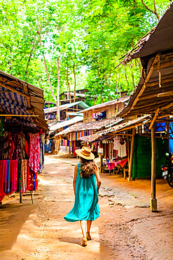 Woman walking in village street, Thailand, Southeast Asia, Asia