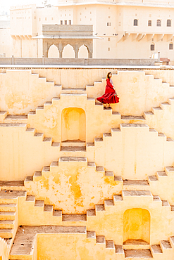 Woman in red garment at Panna Meena ka Kund, Jaipur, Rajasthan, India, Asia