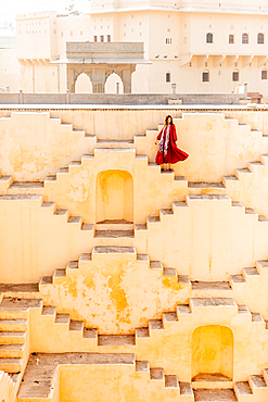 Woman in red garment at Panna Meena ka Kund, Jaipur, Rajasthan, India, Asia