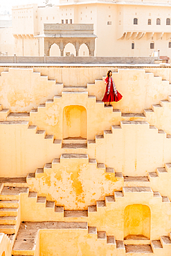 Woman in red garment at Panna Meena ka Kund, Jaipur, Rajasthan, India, Asia