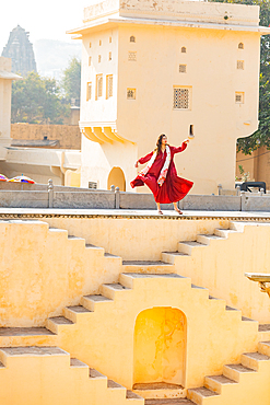 Woman in red garment at Panna Meena ka Kund, Jaipur, Rajasthan, India, Asia