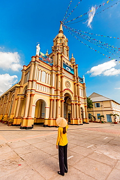 Woman gazing up at a temple, Can Tho, Vietnam, Indochina, Southeast Asia, Asia