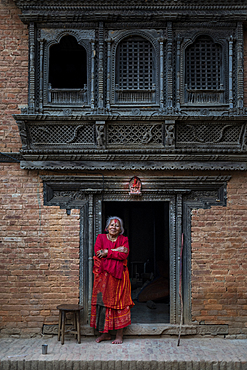 Traditional decorative Newari hand carved wood windows and architecture on a temple in an historical little village, Nuwacot, Nepal, Asia