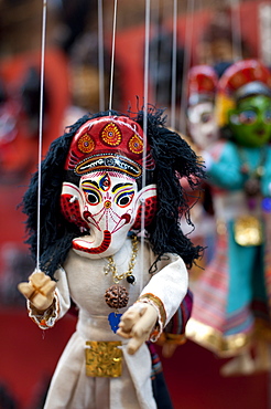 Colourful puppets hanging on display in the historical Newar city of Bhaktapur, Nepal, Asia