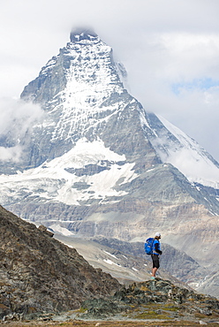 Hiking a trail in the Swiss Alps near Zermatt with a view of The Matterhorn in the distance, Zermatt, Valais, Switzerland, Europe