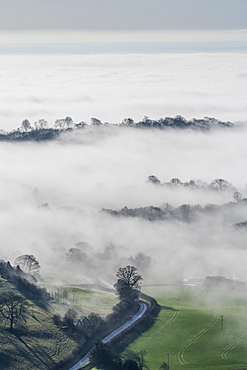 Mist and winter sunlight over Kilburn village and the Vale of York from above the White Horse of Kilburn, Yorkshire, England, United Kingdom, Europe