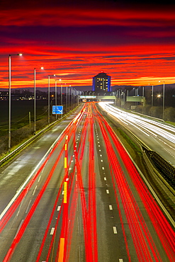 Red sky sunset, traffic light trails, M8 Motorway, Scotland, United Kingdom, Europe