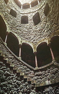 View of spiral staircases at the Initiation Well, purportedly used for ceremonial purposes by Freemasons in the 19th century, at Quinta da Regaleira, Sintra, Portugal, Europe