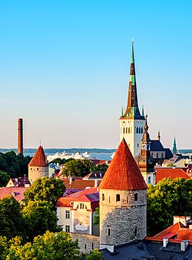 View over the Old Town towards St Olaf's Church at sunset, Tallinn, Estonia