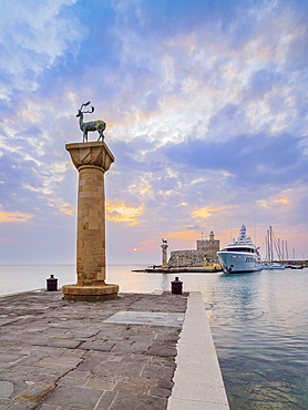 Deer and Doe on columns at the entrance to Mandraki Harbour, former Colossus of Rhodes location, Saint Nicholas Fortress in the background, sunrise, Rhodes City, Rhodes Island, Dodecanese, Greek Islands, Greece, Europe