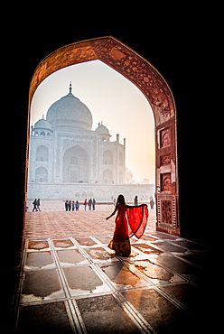 A lady twirls as the sun rises behind the Taj Mahal, UNESCO World Heritage Site, Agra, Uttar Pradesh, India, Asia