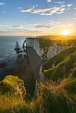 Sun rays at dawn at the cliffs, Etretat, Normandy, France, Europe