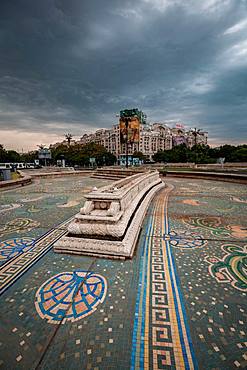 An empty fountain and impending storm in Bucharest, Romania, Europe