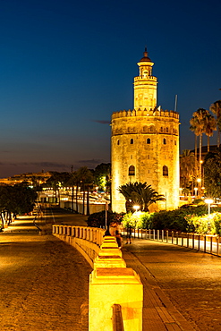 Sunset at Torre del Oro (Tower of Gold), a watchtower on the bank of the Guadalquivir River in Seville, Andalusia, Spain, Europe