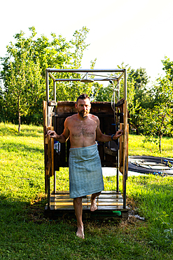 man taking a shower in the garden