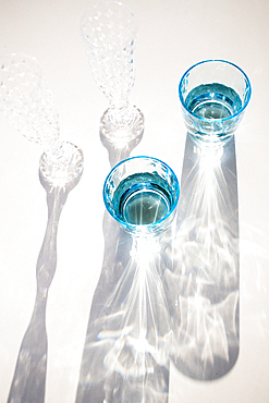 still life with vintage water and champagne glasses in the sun