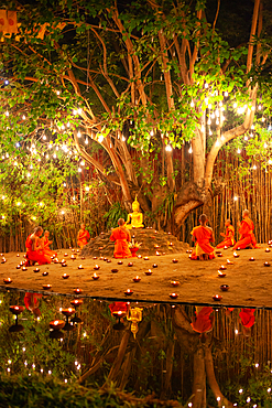 Makha bucha day celebrations in Chiangmai.Traditional monks pray under illuminated Buddha statue annually at Wat Phan Tao temple in Chiangmai,Thailand