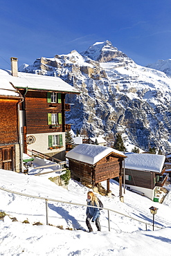 A girl walks in the village, Murren, Lauterbrunnen valley, Canton of Bern, Switzerland, Europe