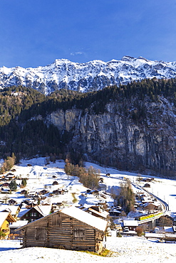 Traditional huts with the transit of the train, Lauterbrunnen, Canton of Bern, Switzerland, Europe