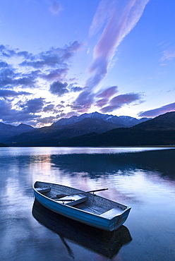 Single moored boat in the Lake of Sils at sunrise, Maloja pass, Engadine valley, Graubunden, Switzerland, Europe